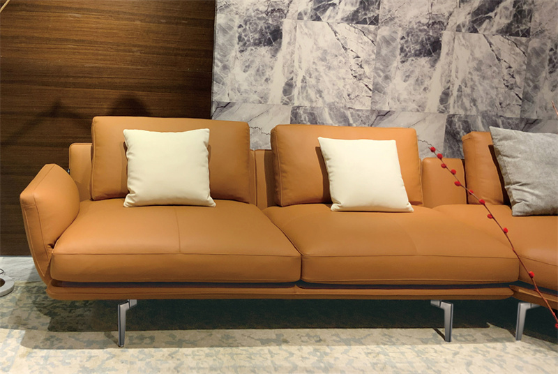 Warm-toned living room scene featuring a sofa, highlighting DELTA CAINA's stylish and durable sofa legs, designed to enhance furniture aesthetics and stability.
